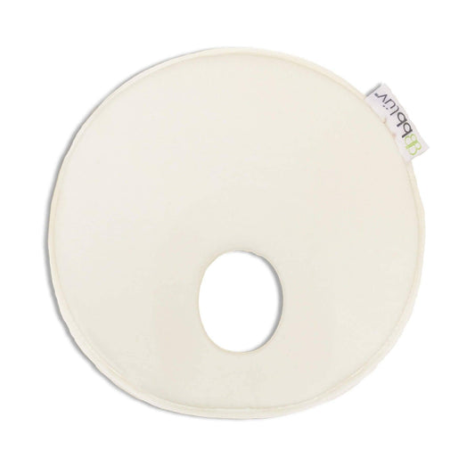 Round white cushion with a small hole in the center on a white background