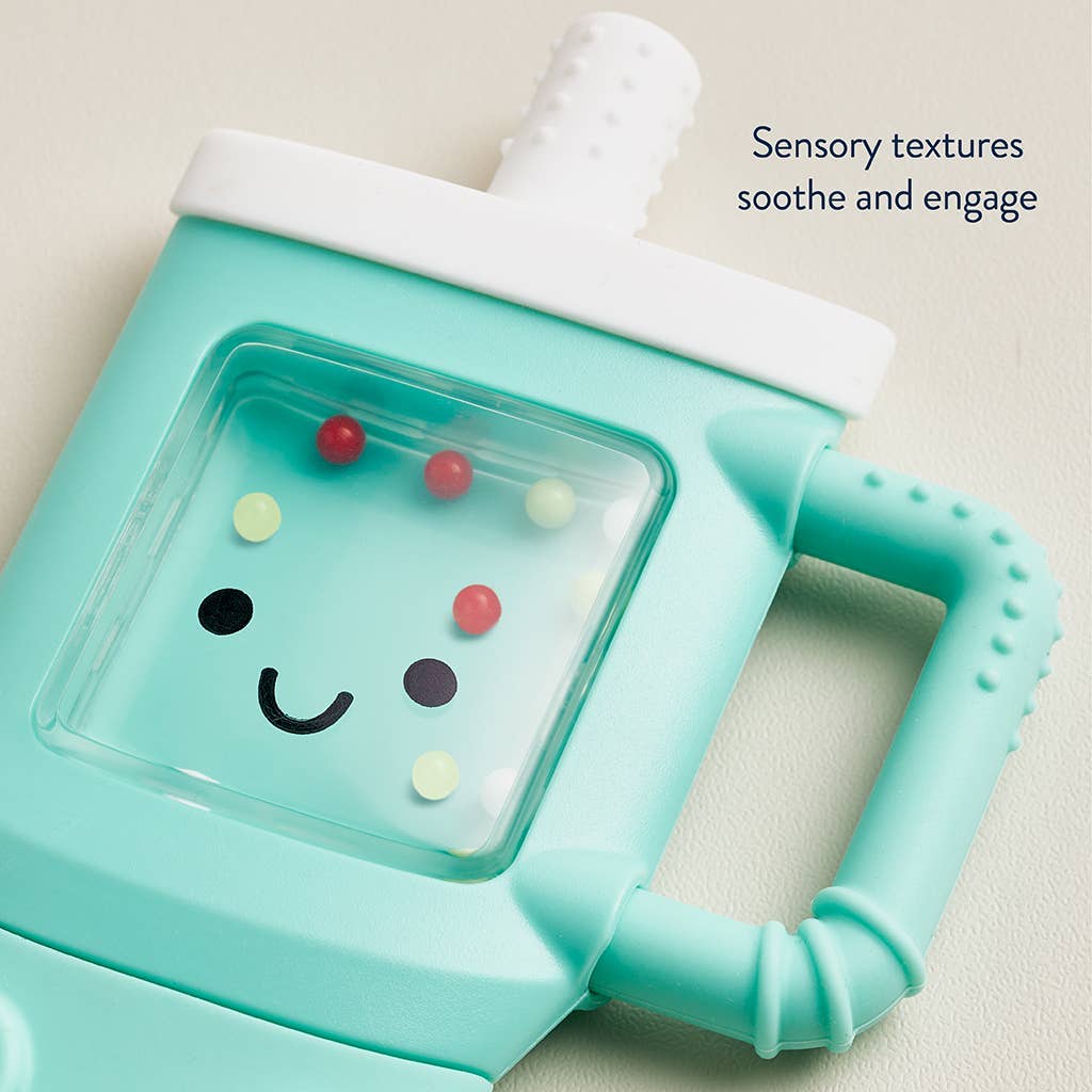 Teal baby teether with a smiley face design on a light beige background