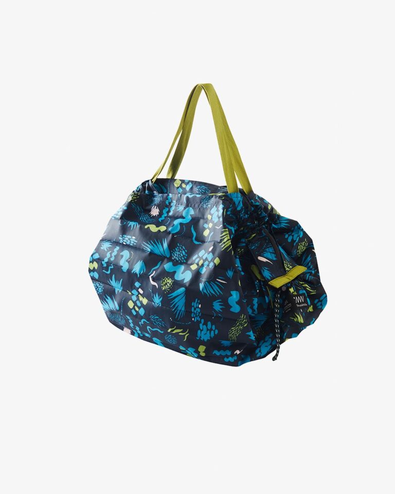 Blue patterned bag with green straps on a white background