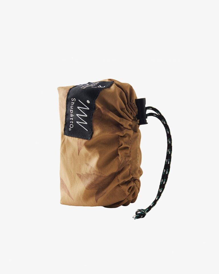 Brown drawstring bag with a black tag on a white background